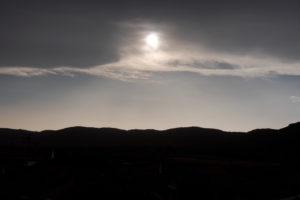 As the solar eclipse began, the sun slowly set As the solar eclipse began, the sun slowly set